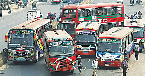 Multiple buses are tightly packed across the lanes.
