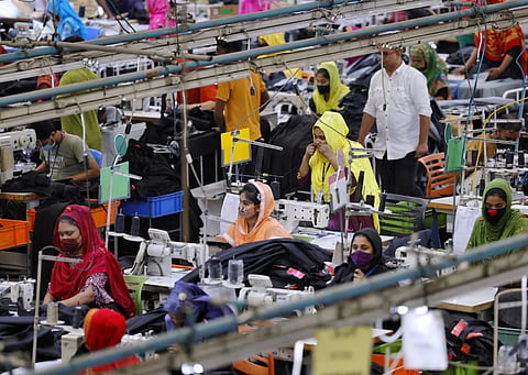 Bangladeshi garment workers make clothing in the sewing section of a factory in Gazipur, Bangladesh, April 9, 2025. 