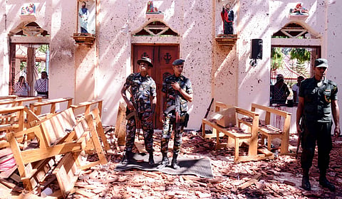 Sri Lankan security forces stand guard inside St. Sebastian's Church in Negombo after the devastating Easter Sunday bombings on April 21, 2019.