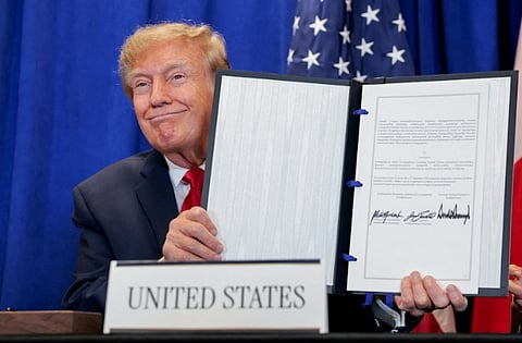 Trump shows the signed document on Greenland deal in New York City, September 22, 2026. 