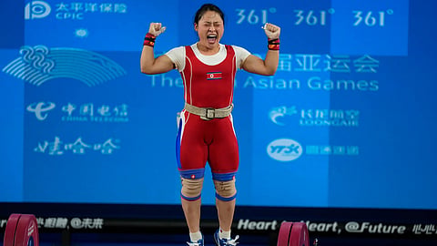 North Korean weightlifter Ri Song Gum celebrates after breaking the world record at the Asian Games 2026.