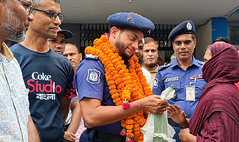 People gathered at Harirampur Police Station on Wednesday to bid farewell to outgoing Officer-in-Charge Afzal Hossain