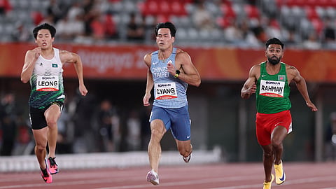 Bangladesh's Imranur Rahman in action alongside Taiwan's Chun-han Yang and Macau's Lok Io Leong during the men's 100m Round 1 Heat 5 at the Asian Games in Nagoya, Japan.