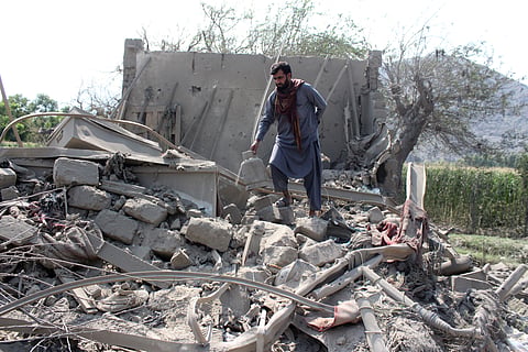 A man retrieves belongings from the debris of a house that was damaged in what the Taliban said was a Pakistani airstrike in Kunar province, Afghanistan, September 21, 2026.