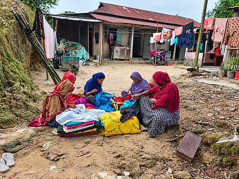 Runa Begum (at the center) along with others are sewing Nakshi Kantha