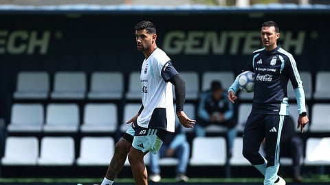 Cristian Romero of Argentina during training as head coach Lionel Scaloni looks on.