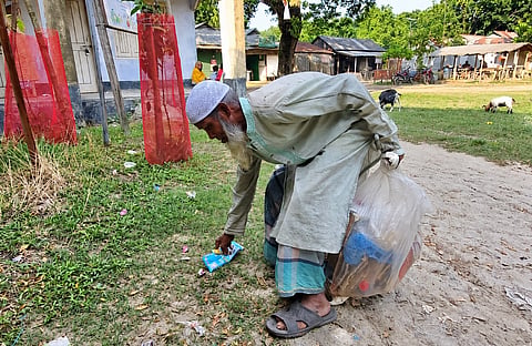 Hazrat Ali is collecting rubbish in Babuganj Bazar