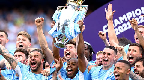 Fernandinho lifts the Premier League trophy with Manchester City teammates after their 2022 title win.