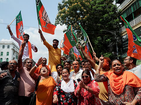 India's ruling Bharatiya Janata Party (BJP) supporters celebrate as early trends show their party leading in the West Bengal state assembly election results, outside the party's regional office in Kolkata, India, May 4, 2026