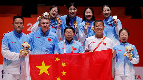 Gold medallists China's Junyao Tang, Sihan Yu, Chang Liu, Jingwen Yang and team pose with a flag on the podium after the Women's Epee Team.