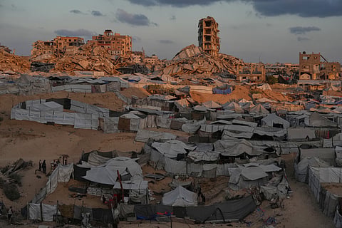 Tents sheltering displaced Palestinians are seen amid war-damaged buildings in Gaza City, Saturday, Sept. 26, 2026. 