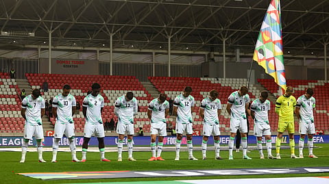 Republic of Ireland players wearing black armbands in recognition of all lives lost in the Gaza conflict bow their heads and during the Israel national anthem before the match.
