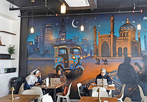 Customers work at Qisa Coffee in Sacramento, California, a Peshawar-inspired café that has become a gathering place for the city’s Muslim community