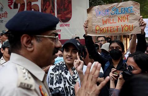 College students talk with a police officer during a solidarity march demanding police action and better safety for women following the alleged gang rape of a girl, in New Delhi, India, September 23, 2026.