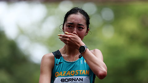 Kazakhstan's Yasmina Toxanbayeva celebrates finishing in first place to win the gold in the Women's Marathon Race Walk.