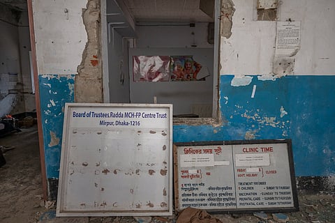 Signboards listing the Radda MCH-FP Centre’s trustees, clinic hours and services stand amid the damaged premises in Mirpur-1