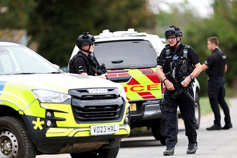 Armed police officers work on a road outside the perimiter of the RAF Fairford airbase, after police declared a major incident at the base after several men were arrested on suspicion of offences under the Explosives Act, in Fairford, Gloucestershire, Britain, September 27, 2026.