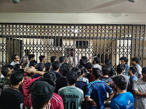 Students of Sylhet Engineering College confine teachers inside the college building in a bid to push home their demands on September 28, 2026. 
