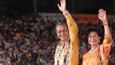 Siti Hasmah (R) and Mahathir Mohammad (L) wave during a public rally in Kuala Lumpur in 2003.