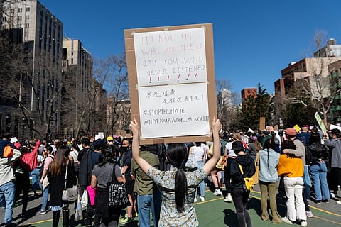 A person holds up a sign during a Rally Against Hate to end discrimination against Asian Americans and Pacific Islanders in New York City, U.S., March 21, 2021