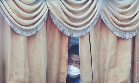 A Myanmar national to be repatriated from Malaysia sits inside a bus, at Lumut, Malaysia, September 29, 2026. 