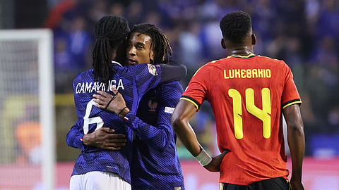 France's Michael Olise and Eduardo Camavinga celebrate after the match.