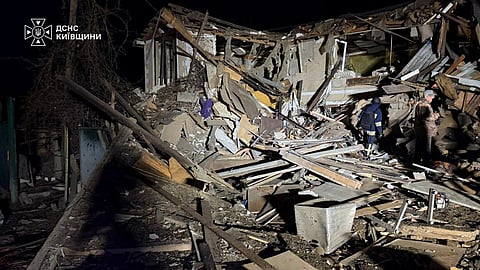 In this photo provided by the Ukrainian Emergency Services on Wednesday, Sept. 30, 2026, rescuers put out a fire in a garage destroyed after a Russian drone strike on Kyiv region, Ukraine.