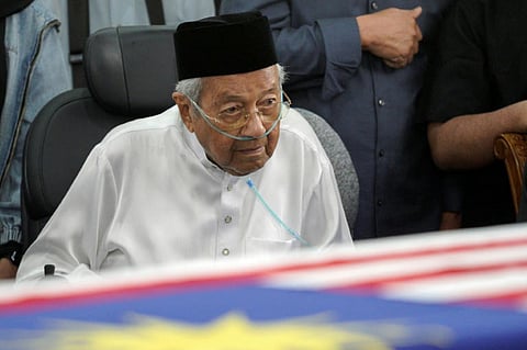 Mahathir Mohamad looks at the casket of his wife, Siti Hasmah Mohamad Ali, during her funeral ceremony on September 28.