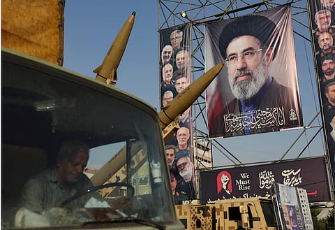 Iranian missiles are displayed next to a banner with a picture of Iran's Supreme Leader, Mojtaba Khamenei, on a street in Tehran, Iran, September 27, 2026.