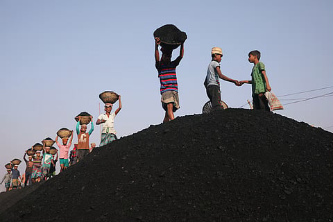 Coal workers are seen at a market as they unload a ferry in Dhaka, Bangladesh, January 13, 2019. 