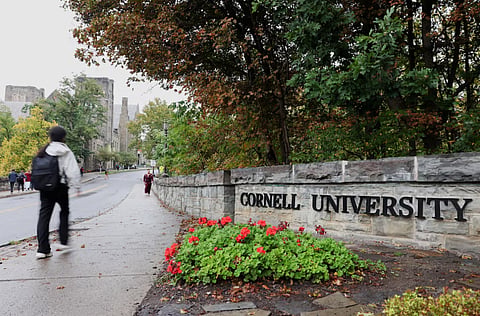 A student walks by a sign at the entrance of Cornell University in Ithaca, New York, US, October 1, 2026.
