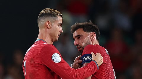 Portugal's Cristiano Ronaldo hands the captain's armband to Bruno Fernandes as he is substituted off.