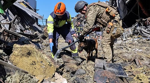 Rescuers with a dog work at a site of a shopping centre destroyed by yesterday's Russian drone attack, amid Russia's attack on Ukraine, in the city of Kryvyi Rih, Dnipropetrovsk region, Ukraine August 22, 2026.