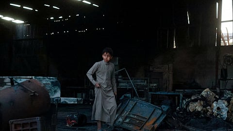 A boy walks at a factory damaged by an airstrike in Sanaa, Yemen October 4, 2026.