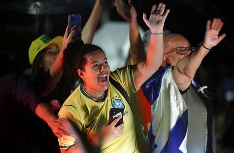 Supporters of Brazilian presidential candidate Flavio Bolsonaro of the Liberal Party (PL) react as he leaves, after the country's electoral authority said Bolsonaro will face President Luiz Inacio Lula da Silva in the runoff of a presidential election, in Brasilia, Brazil October 4, 2026