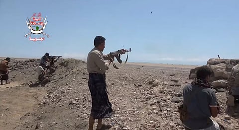 Pro-Saudi-backed Yemeni government fighters fire their weapons during what government forces say was an advance against the Iran-backed Houthis, near Dhubab, Taiz Governorate, Yemen, in this still image taken from video released October 5, 2026. 