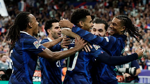France's Michael Olise celebrates scoring their third goal with Desire Doue.