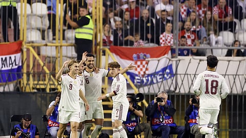 Spain's Mikel Merino celebrates scoring their second goal with teammates.