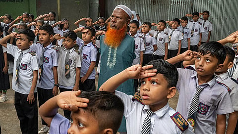 Md Altaf Hossain stands among his students during morning assembly at Pratibha Dukhu Mia Kindergarten School in Panchdona, Narsingdi