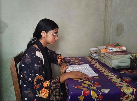 Setu, a 15 year old student is studying confidently with new prescribed spectacles provided by Sightsavers