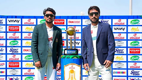 Afghanistan captain Rahmat Shah (R) and Bangladesh captain Najmul Hossain Shanto pose with the trophy.