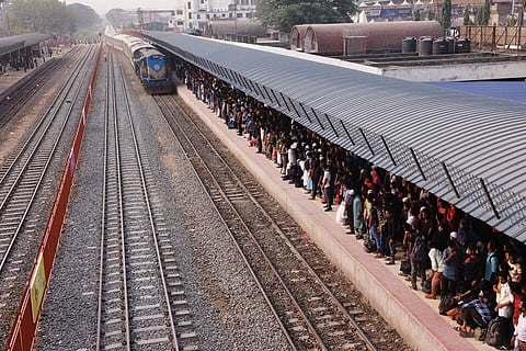 People wait for trains at the Airport Railway Station, to go home ahead of Eid al-fitr, in Dhaka, Bangladesh, April 29, 2022.