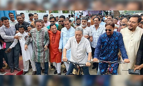 Finance and Planning Minister Amir Khosru Mahmud Chowdhury rides a bicycle on the newly inaugurated 2.2-km cycle track on Airport Road in Chattogram on Friday.