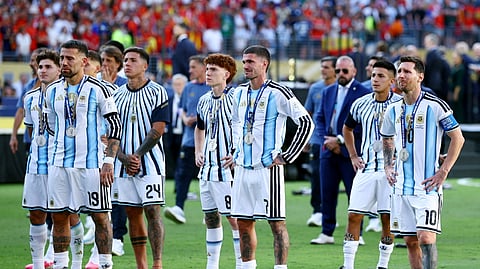 Argentina's Lionel Messi, Nicolas Otamendi, Rodrigo De Paul and Enzo Fernandez look dejected with teammates after losing the World Cup final
