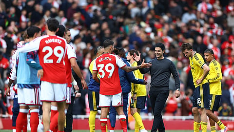 Arsenal manager Mikel Arteta and Bruno Guimaraes celebrate after the match.