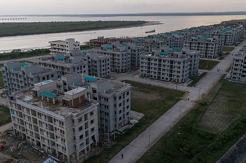 An aerial view of the Khurushkul Ashrayan Project along the Bakkhali River in Cox’s Bazar, where rows of five-story apartment buildings form a vast resettlement complex for families displaced by coastal disasters and airport expansion