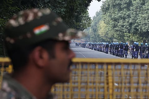  A security official watches as Rapid Action Force (RAF) personnel march on the day of a protest by the Cockroach Janta Party (CJP) seeking the resignation of India's Chief Election Commissioner, Gyanesh Kumar, in New Delhi, India, October 10, 2026. 