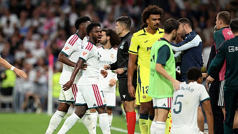 Real Madrid's Vinicius Junior reacts as he leaves the pitch after being shown a red card.