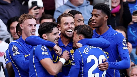 Chelsea's Jordan Henderson (C) celebrates scoring their fifth goal with teammates.