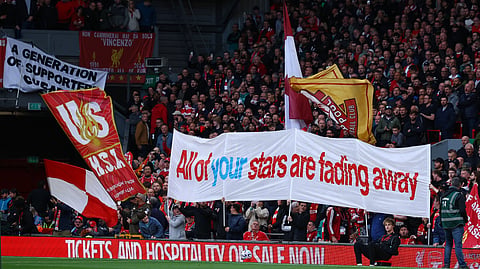 Liverpool fans with a banner related to the Manchester City's Premier League charges inside the stadium before the match.